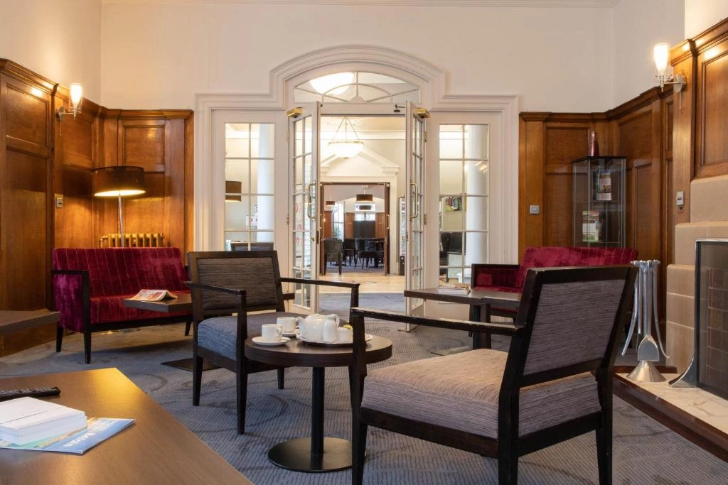 Welcoming lounge with wood panelling and traditional seating at The Caledonian New Southlands Hotel